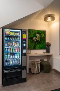 a vending machine with soda cans and a table at Boutique Hotel Prokopovka 34 in Pilsen