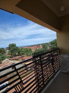 a balcony with a bench and a view at Dorah's Apartment in Entebbe