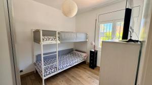 a bedroom with two bunk beds and a window at Villa Lloret De Mar in Lloret de Mar +32 photos