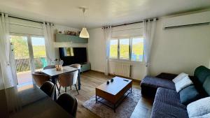 a living room with a couch and a table at Villa Lloret De Mar in Lloret de Mar