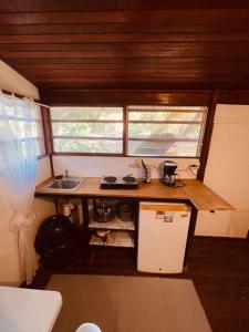 a small kitchen with a counter and a sink at Noni garden apartment in Tamarindo +8 photos
