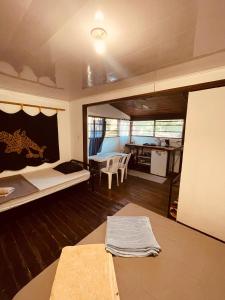 a room with a bed and a table and a kitchen at Noni garden apartment in Tamarindo