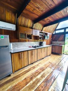 a large kitchen with wooden cabinets and a refrigerator at Quinta Túru in Colonia