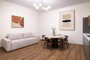 a living room with a couch and a table at Small Luxury In Centro Storico in Parma
