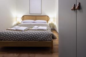 a bedroom with a bed with two towels on it at Small Luxury In Centro Storico in Parma