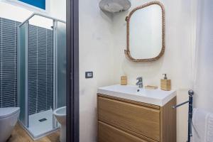a bathroom with a sink and a mirror at Small Luxury In Centro Storico in Parma +10 photos