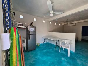 a room with a table and chairs and a refrigerator at Alojamiento Turquesa in Barrio Nuevo +2 photos