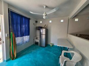 a room with a blue floor with a surfboard in it at Alojamiento Turquesa in Barrio Nuevo