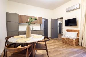 a kitchen and dining room with a table and chairs at Small Luxury In Centro Storico in Parma