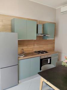 a kitchen with blue and white cabinets and a table at Il Rovo Casa vacanze in Cava deʼ Tirreni +6 photos