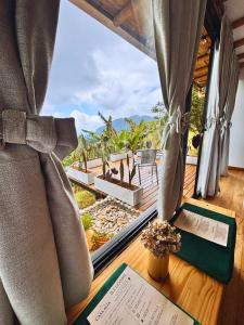 a window with a view of the ocean from a resort at Casa Alta Colombia, ecolodge con vistas, Pereira in Dosquebradas