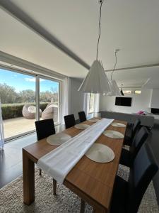 a dining room with a wooden table and chairs at Villa Nika in Bečići