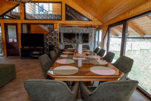 a conference room with a long wooden table and chairs at Greenhouse Klara with heated pool in Tršće