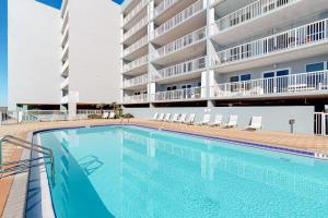 a large swimming pool in front of a building at Spacious gulf front condo with beach access in Fort Walton Beach +41 photos