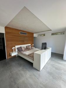 a bedroom with a bed and a desk with a television at Villa Nika in Bečići