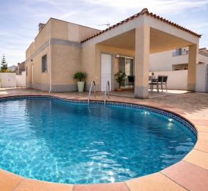 a large swimming pool in front of a house at Sa Tuna - Delta de l'Ebre in Riumar