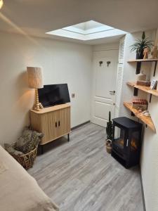 a living room with a flat screen tv and a fireplace at Zandvoort Beach Escape 2P in Zandvoort