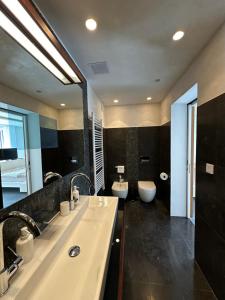 a bathroom with a large sink and a toilet at Villa Nika in Bečići +17 photos