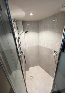 a shower with a glass door in a bathroom at Zandvoort Beach Escape 2P in Zandvoort +10 photos