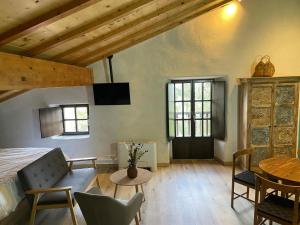 a bedroom with a bed and a table and chairs at Gautegiz Arteaga Reserva Urdaibai in Isla Becoa