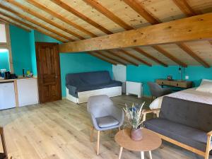 a bedroom with a bed and a couch and a table at Gautegiz Arteaga Reserva Urdaibai in Isla Becoa