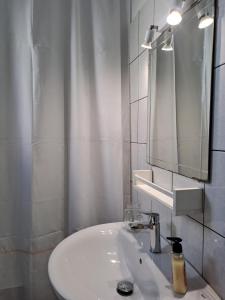 a white bathroom with a sink and a mirror at Naxos olive & home in Engares +67 photos