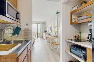 a kitchen with a sink and a counter top at Coastal condo with shared pool beaches shopping in Fort Walton Beach +6 photos