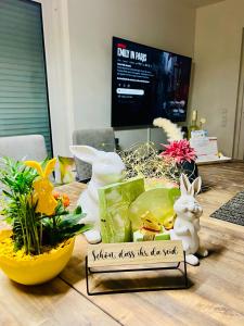 a table with figurines of rabbits and a sign on it at Ferienhaus Waldblick in Hohenfels-Essingen