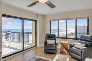 a living room with a view of the ocean at Sunrise beach views with top complex amenities and pool access! in Ormond Beach