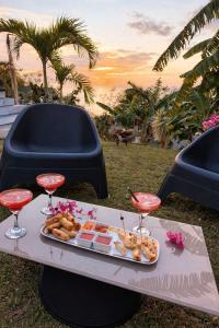a table with a tray of food and wine glasses at Villa zion in Deshaies
