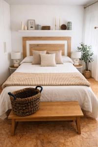 a bedroom with a large bed with a basket on a table at Sa Tuna - Delta de l'Ebre in Riumar +17 photos