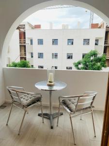 a table and two chairs and a table and a window at EL MARINERITO Alcocebre in Alcossebre +21 photos