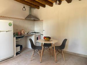 a kitchen with a table and chairs and a refrigerator at Usina Elias in Tilcara +25 photos