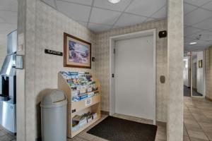a hallway with a white door in a store at Wilshireinn Hotel in Claresholm