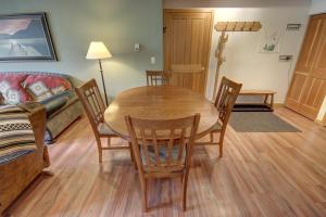 a living room with a wooden table and chairs at Gateway Lodge 5030 by SummitCove Lodging in Colorado in Keystone