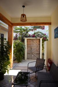 an open door to a patio with a wooden gate at Sun Beach Dhigurah in Dhigurah