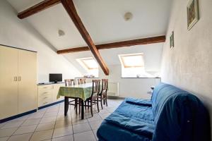 a living room with a table and a couch at Hotel Primula in Alassio