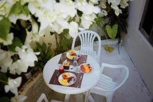 a white table with plates of food on it at Sun Beach Dhigurah in Dhigurah +13 photos