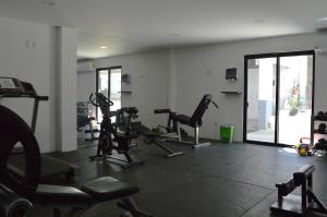 a gym with treadmills and ellipticals in a room at Morgan Apart-Hotel & Residences in Cabo San Lucas