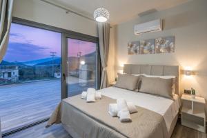 a bedroom with a bed and a large window at Villa La Bianca in Marketáta +52 photos