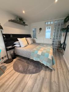 a bedroom with a bed and a wooden floor at Studio Tavros in Bristol