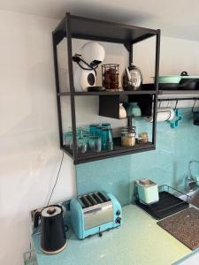 a kitchen with a counter with a toaster on a shelf at Studio Tavros in Bristol +12 photos