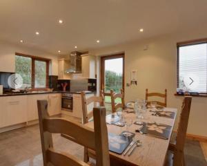 a kitchen and dining room with a table and chairs at Eureka Whitsands in Antony
