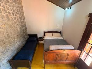 a small room with two beds and a couch at Refúgio Carangola in Petrópolis