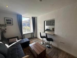 a living room with a couch and a table at Kurvilla Apartments in Landstuhl