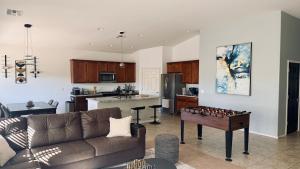 a living room with a couch and a table at 4bed 2bath Retreat - 120inch Theater in Corona de Tucson