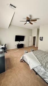 a bedroom with a bed and a ceiling fan at 4bed 2bath Retreat - 120inch Theater in Corona de Tucson