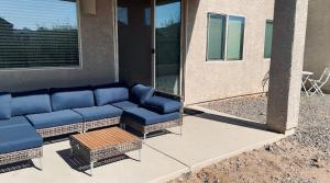 a couch sitting on a patio in front of a house at 4bed 2bath Retreat - 120inch Theater in Corona de Tucson