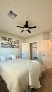 a bedroom with a bed with a ceiling fan at 4bed 2bath Retreat - 120inch Theater in Corona de Tucson
