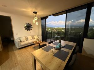 a living room with a table and a couch at Modern Apartment With Espectacular Panoramic Views in Pereira